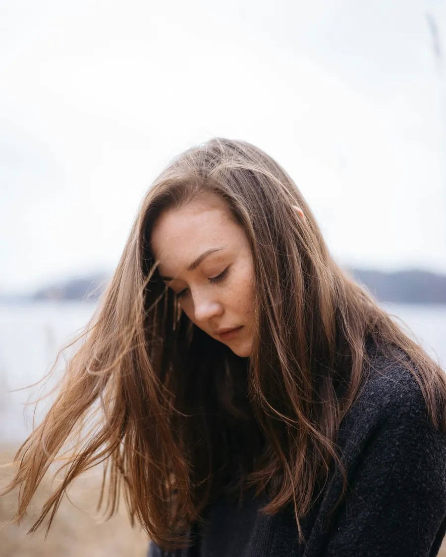 Woman with long hair looking down